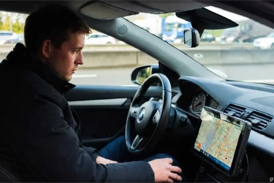 Long-Distance Road Trip Logistics in Western Europe: 2026 Practical Guide 6 Driver parked in a parking lot next to a busy highway in Germany checking a route map on the car's navigation system